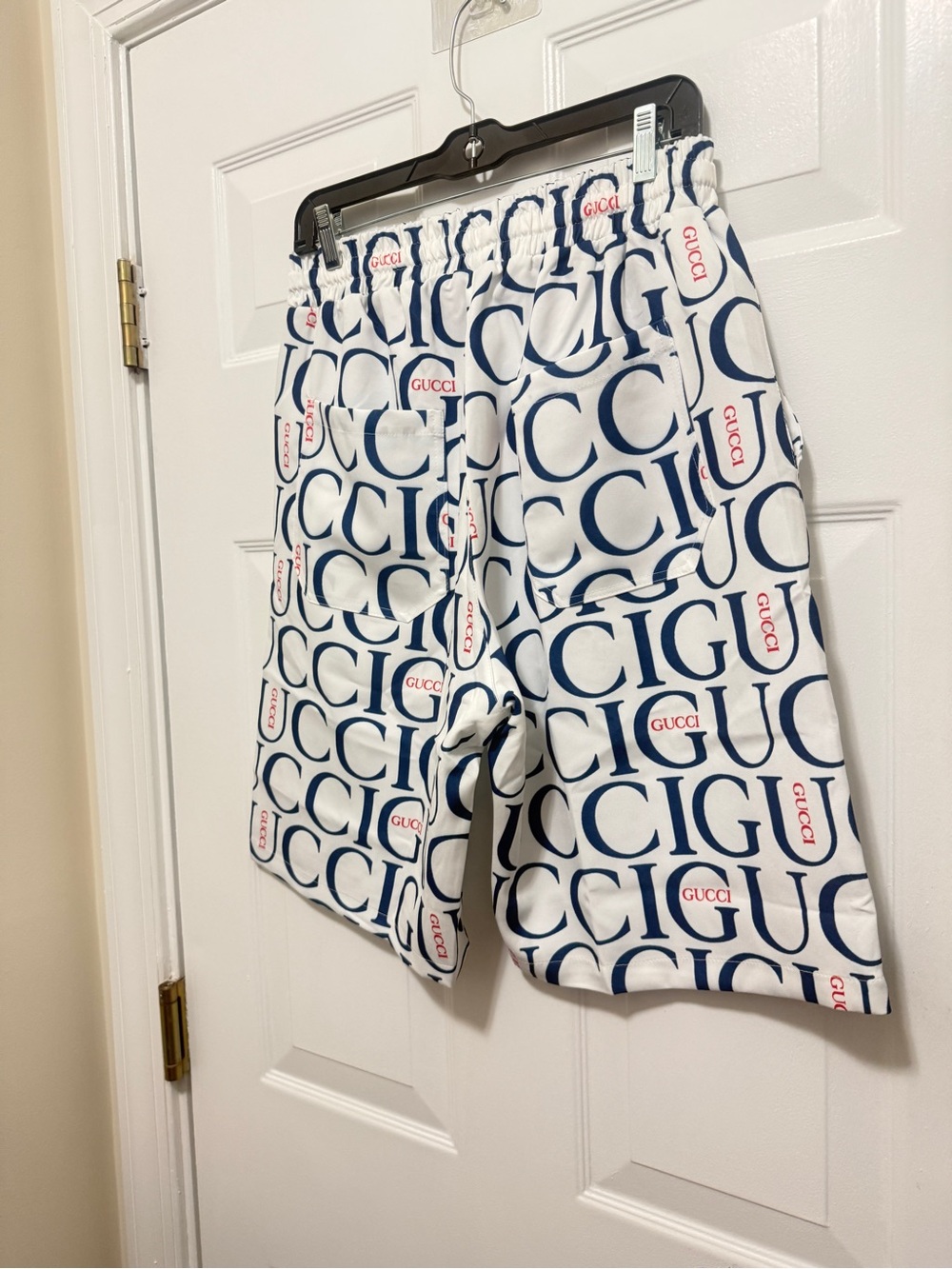 Beautiful shorts featuring a navy-and-red logo print with red accents. new - Picture 9 of 11